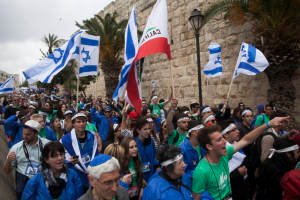 Jewish youth march near the walls of the old city in Jerusalem