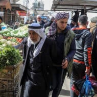 Palestinians shop in the market in Rafah