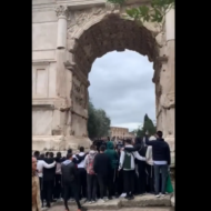 A group of Jewish people sing "If I Forget You, Oh Jerusalem" at the Arch of Titus in Rome.