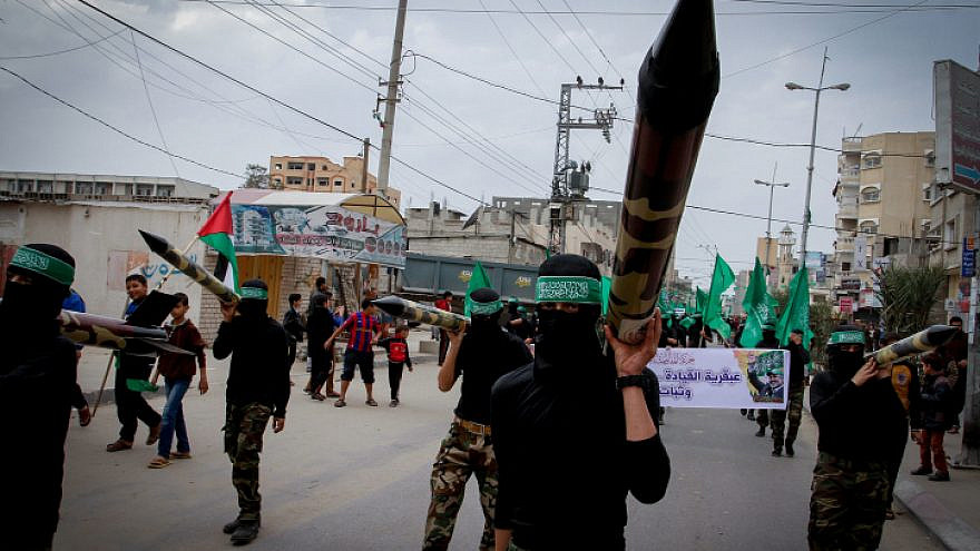 Masked members from the Ezzedine al-Qassam carry a model of a rocket during a rally to commemorate the 27th anniversary of the Islamist movement creation Hamas, at the Nuseirat refugee camp in the Central Gaza Strip on Dec. 12, 2014. Photo by Abed Rahim Khatib/Flash90.

