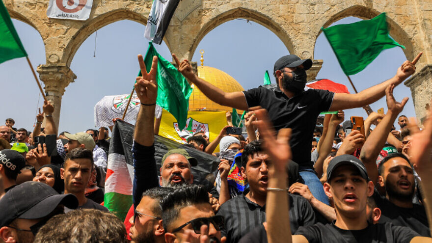 Palestinians wave Hamas flags outside the Al-Aqsa mosque on the Temple Mount in Jerusalem during the last Friday of Ramadan, April 29, 2022. Photo by Jamal Awad/Flash90.
