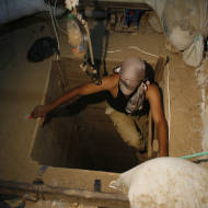 A terrorist emerges from a tunnel. (Khaled Omar/propaimages)