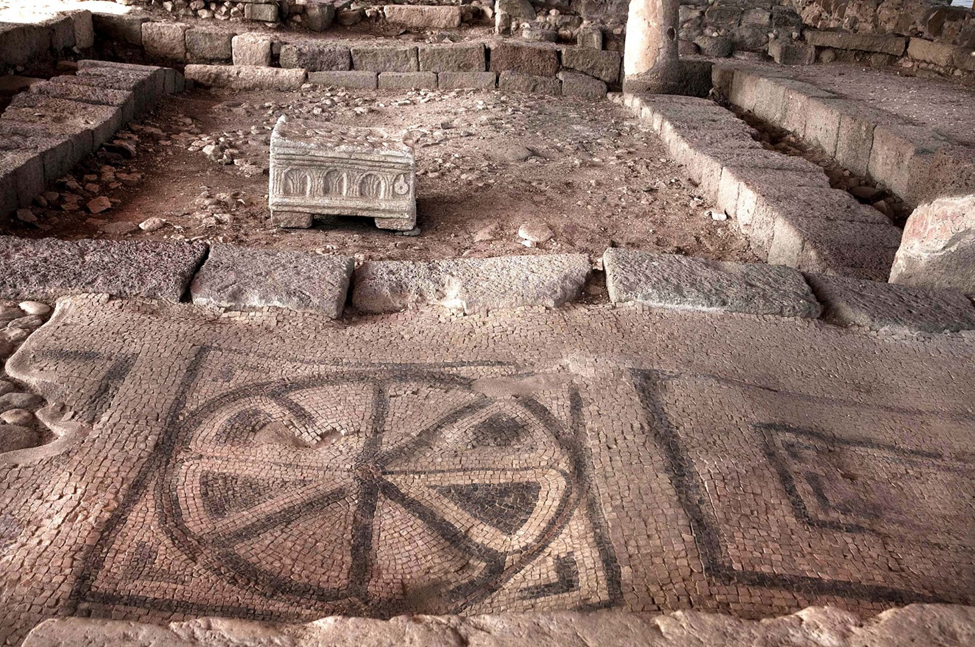 A mosaic with a large rosette pattern inside the main hall of the synagogue. Photo Credit: גל עמוס – CC BY-SA 4.0