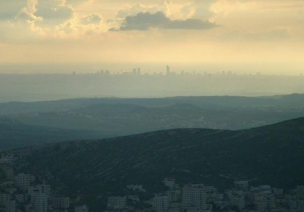 Mount Ebal, roughly at the center of the country, has a stunning, panoramic view of much of the country. The Skyscrapers of Tel Aviv and the Mediterranean Sea can be seen in the background, while the city of Nablus (Shechem) and Mount Gerizim (behind it) can be seen in the foreground. Photo Credit: Arieleizen CC BY-SA 3.0