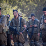 Religious IDF soldiers pray during training.