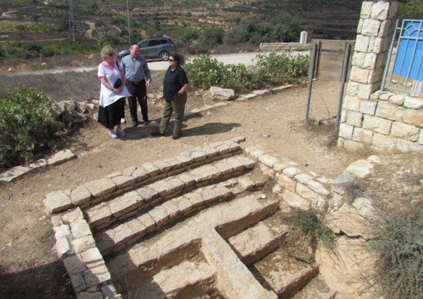 In this picture, I am showing my tourists the stairs to the Mikveh. At this location 2000 years ago, worshippers would enter on the left impure and come out on the right side purified. The barrier wall in the middle was there to ensure the purified did not come into physical contact with those yet to become pure or else they would have to re-enter the ritual bath again. In this picture, I am showing my tourists the stairs to the Mikveh. At this location 2000 years ago, worshippers would enter on the left impure and come out on the right side purified. The barrier wall in the middle was there to ensure the purified did not come into physical contact with those yet to become pure or else they would have to re-enter the ritual bath again.